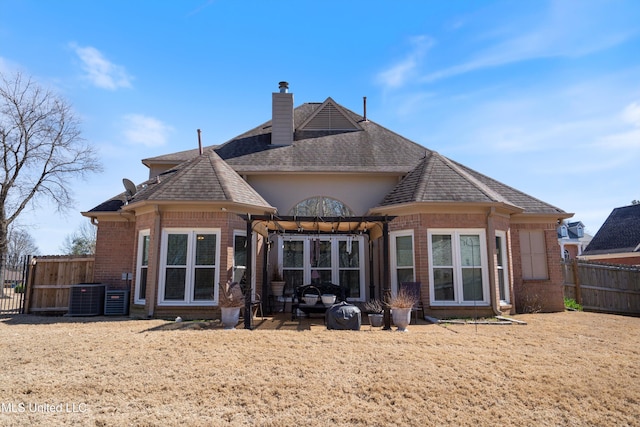 9476 Plantation Rd, Olive Branch, MS 38654 - back of house with fence, a shingled roof, a chimney, central air condition unit, and brick siding