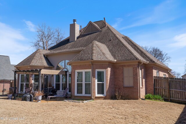 9476 Plantation Rd, Olive Branch, MS 38654 - rear view of property with brick siding, a shingled roof, a chimney, and fence
