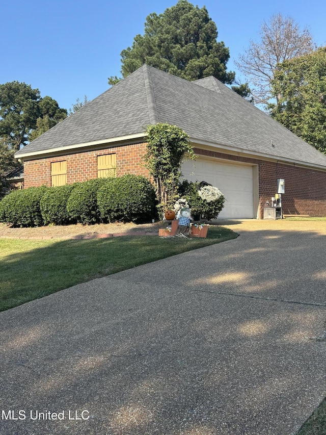 140 Devlin Springs Dr, Madison, MS 39110 - view of side of home with brick siding, an attached garage, driveway, and roof with shingles