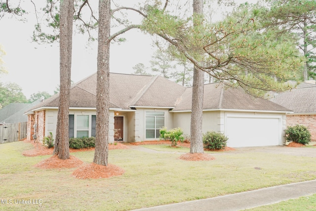 ranch-style house featuring a garage and a front yard