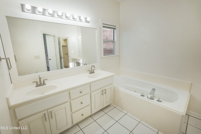 bathroom featuring tile patterned floors, a bathtub, and vanity