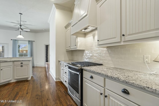 kitchen featuring stainless steel range with gas cooktop, dark wood-style flooring, ornamental molding, custom range hood, and tasteful backsplash