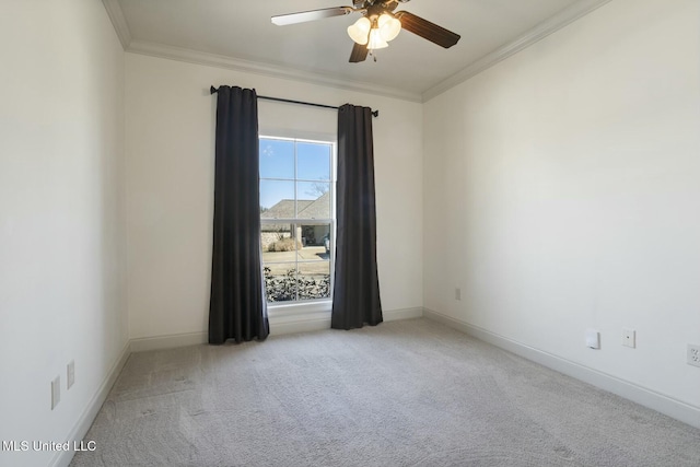 spare room with baseboards, light carpet, ornamental molding, and a ceiling fan