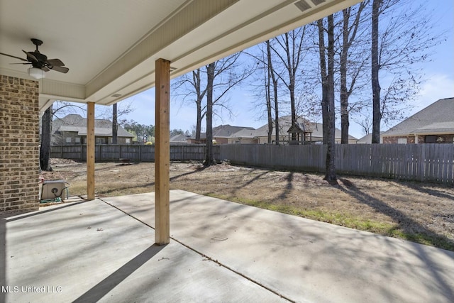 view of patio / terrace featuring a fenced backyard, a residential view, and a ceiling fan