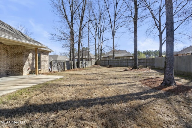 view of yard featuring a patio and a fenced backyard