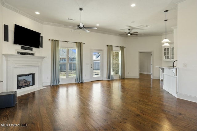 unfurnished living room featuring visible vents, a fireplace, and ornamental molding