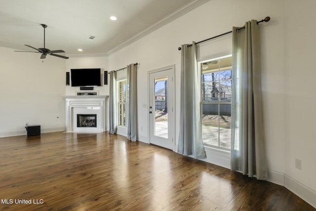 unfurnished living room with wood finished floors, recessed lighting, a fireplace, ceiling fan, and crown molding