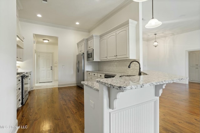 kitchen with light stone countertops, a breakfast bar area, a peninsula, stainless steel appliances, and a sink