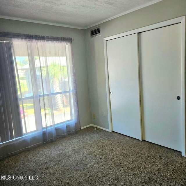 266 Lanai Unit U, Diamondhead, MS 39525 - unfurnished bedroom with visible vents, carpet flooring, crown molding, and multiple windows