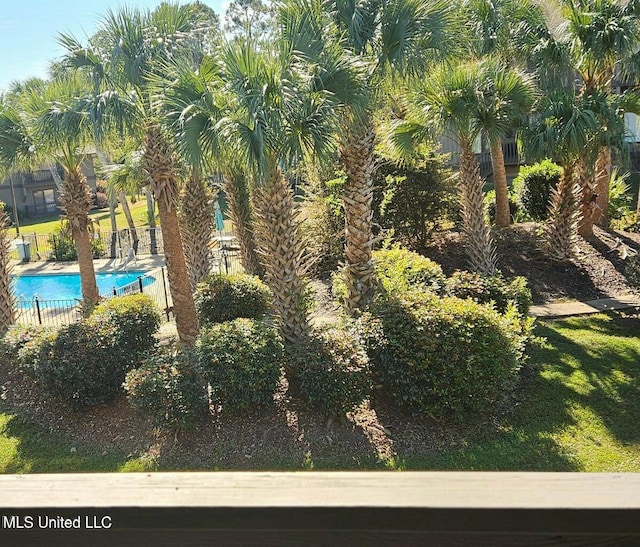 266 Lanai Unit U, Diamondhead, MS 39525 - view of yard featuring a community pool and fence