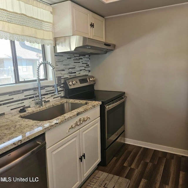 266 Lanai Unit U, Diamondhead, MS 39525 - kitchen with backsplash, a sink, under cabinet range hood, stainless steel appliances, and white cabinetry