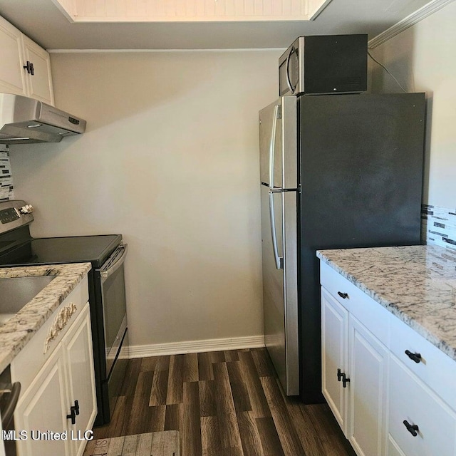 266 Lanai Unit U, Diamondhead, MS 39525 - kitchen featuring white cabinets, dark wood-style flooring, light stone countertops, appliances with stainless steel finishes, and under cabinet range hood