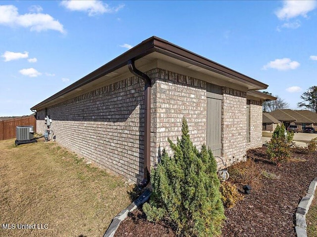 view of home's exterior with a yard and central AC unit