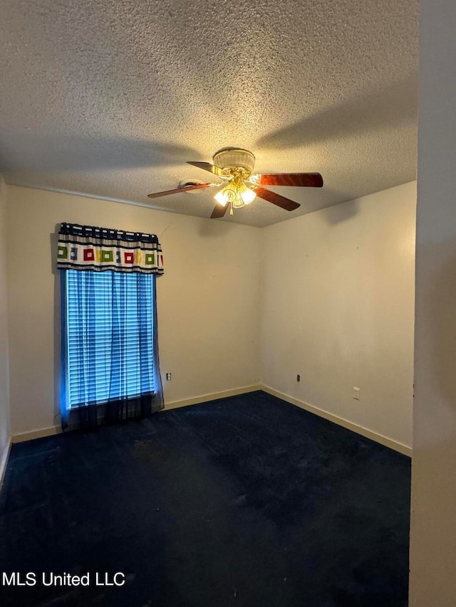 unfurnished room with a textured ceiling, ceiling fan, and carpet floors