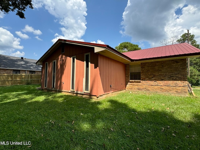 rear view of house featuring a yard