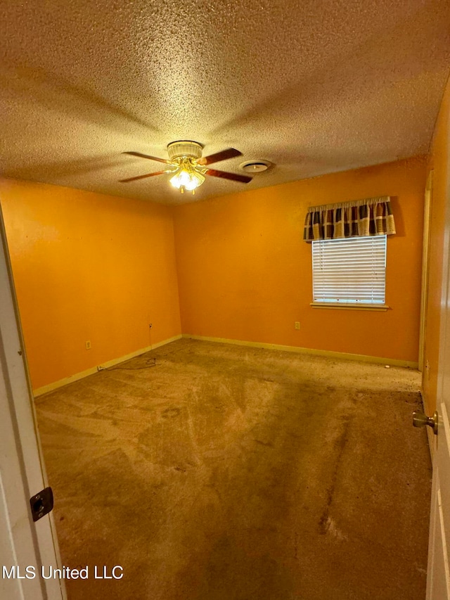 empty room with carpet, a textured ceiling, and ceiling fan