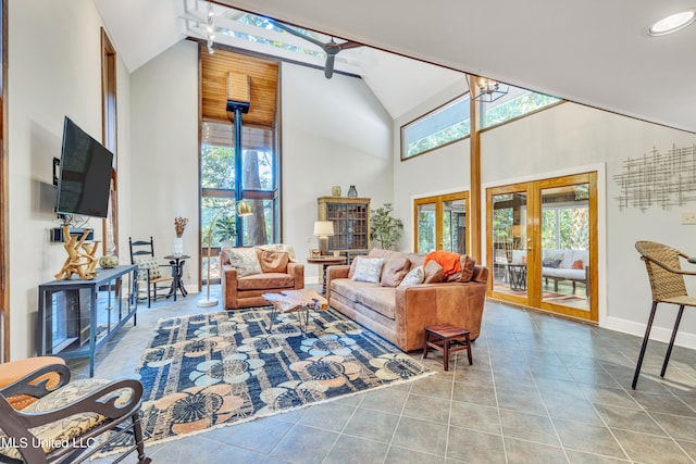 living room with high vaulted ceiling and light tile patterned flooring