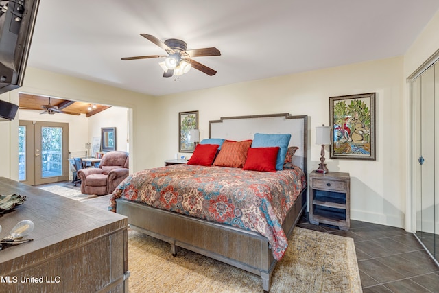 bedroom featuring beam ceiling, ceiling fan, a closet, french doors, and tile patterned floors