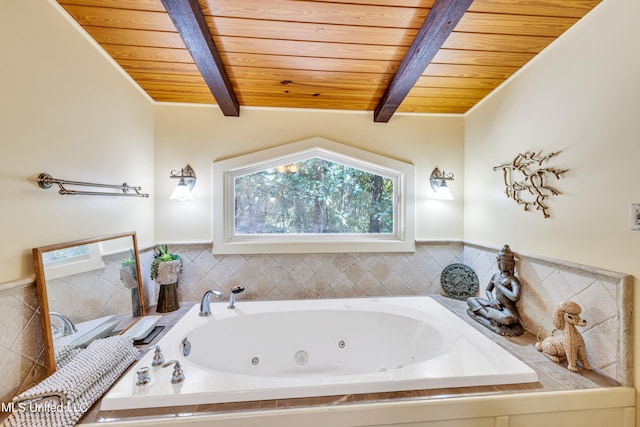 bathroom with a tub to relax in, lofted ceiling with beams, and wooden ceiling