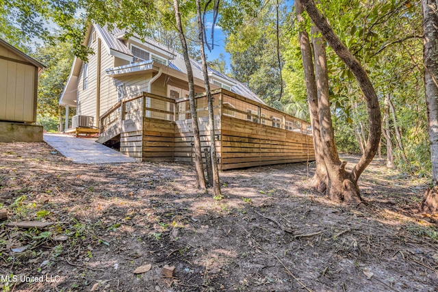 view of side of property featuring central AC