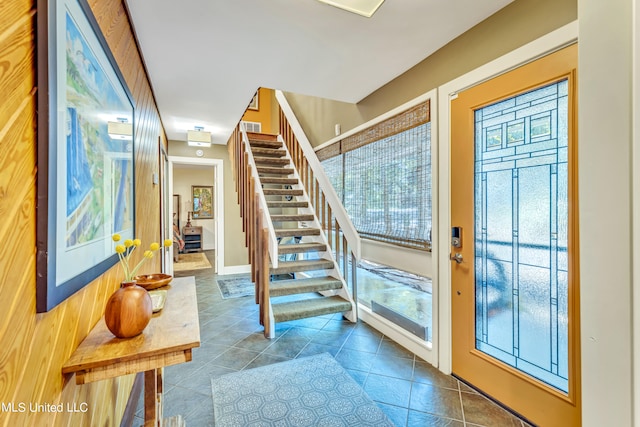 tiled foyer with wooden walls