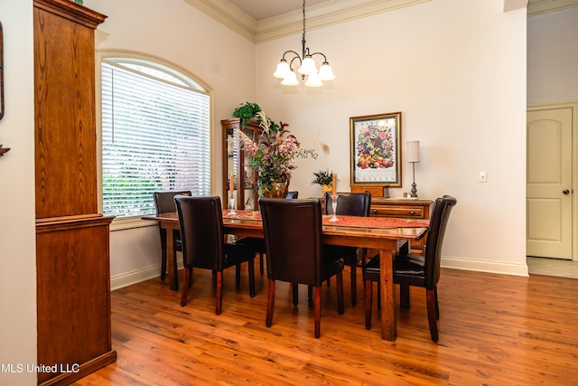 704 Tortoise Rdg, Brandon, MS 39047 - dining space featuring a chandelier, crown molding, wood finished floors, a towering ceiling, and baseboards