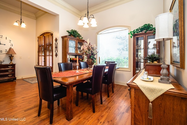704 Tortoise Rdg, Brandon, MS 39047 - dining room with a chandelier, wood finished floors, crown molding, and baseboards