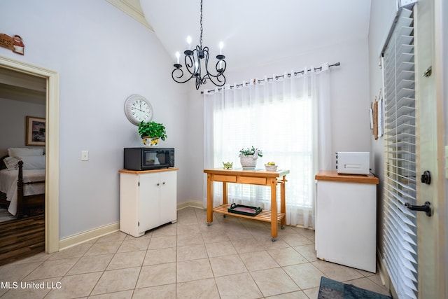 704 Tortoise Rdg, Brandon, MS 39047 - dining area with a chandelier, light tile patterned flooring, baseboards, and high vaulted ceiling