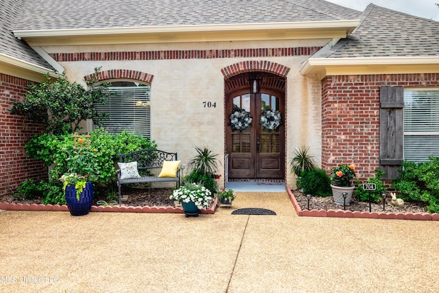 704 Tortoise Rdg, Brandon, MS 39047 - doorway to property featuring a shingled roof, brick siding, and french doors