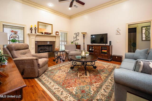 704 Tortoise Rdg, Brandon, MS 39047 - living room featuring crown molding, wood finished floors, ceiling fan, and a fireplace