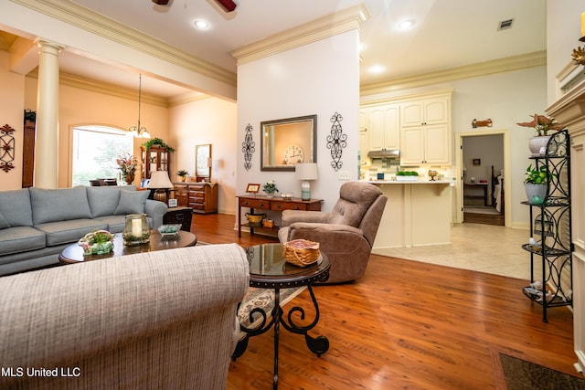 704 Tortoise Rdg, Brandon, MS 39047 - living room featuring ornamental molding, a ceiling fan, and light wood-type flooring