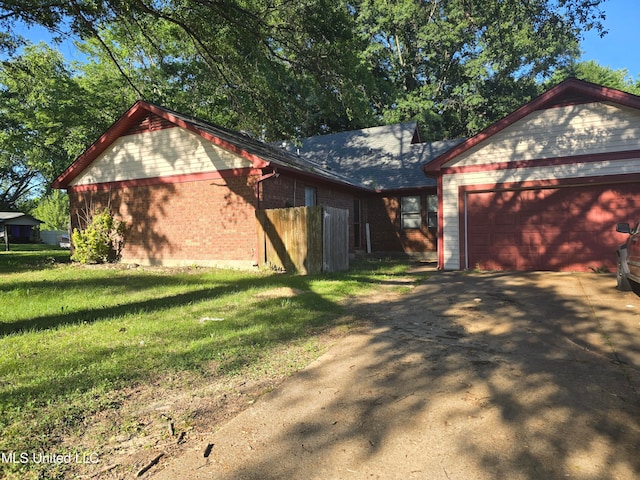 view of side of property with a lawn and a garage