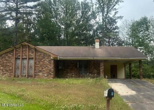 1540 Cedar Pine Dr, Jackson, MS 39212 - single story home with driveway, an attached carport, a chimney, and a front yard