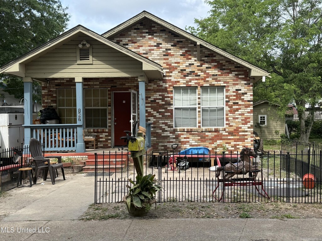 167 Keller Ave, Biloxi, MS 39530 - view of front of home with a porch, brick siding, and a fenced front yard