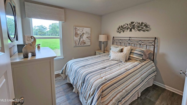 bedroom with dark hardwood / wood-style floors