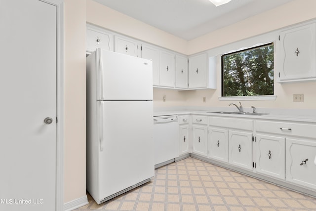 kitchen featuring sink, white cabinetry, and white appliances