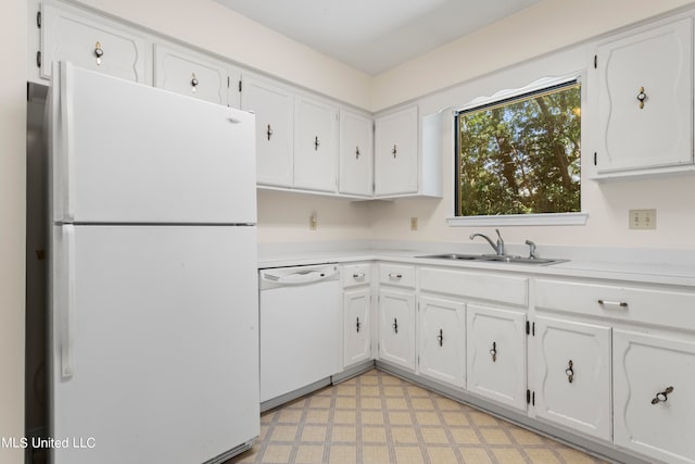 kitchen with white cabinetry, sink, and white appliances