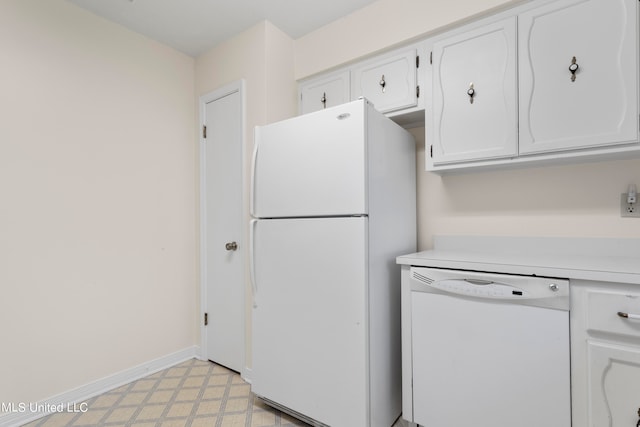 kitchen with white appliances and white cabinets