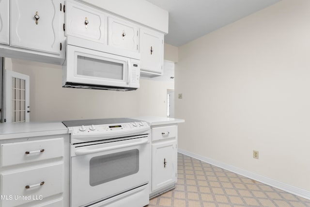 kitchen featuring white cabinetry and white appliances