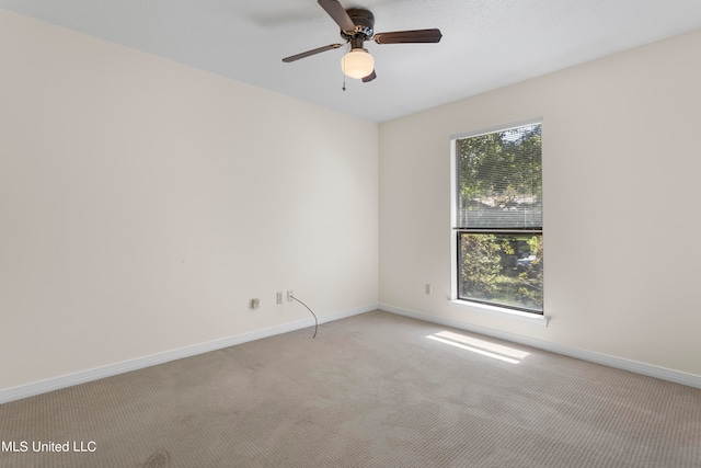 carpeted empty room featuring ceiling fan