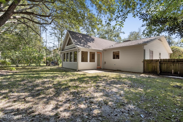 back of property featuring a patio and a yard