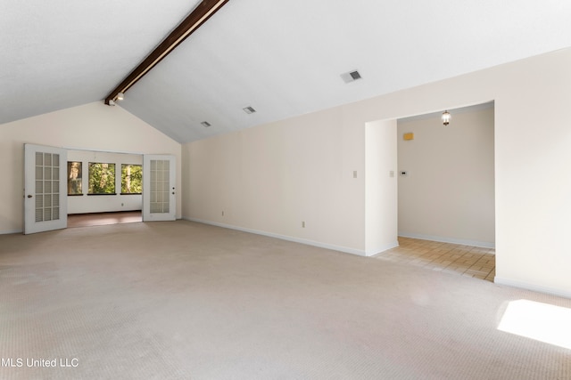 unfurnished living room with lofted ceiling with beams and light colored carpet