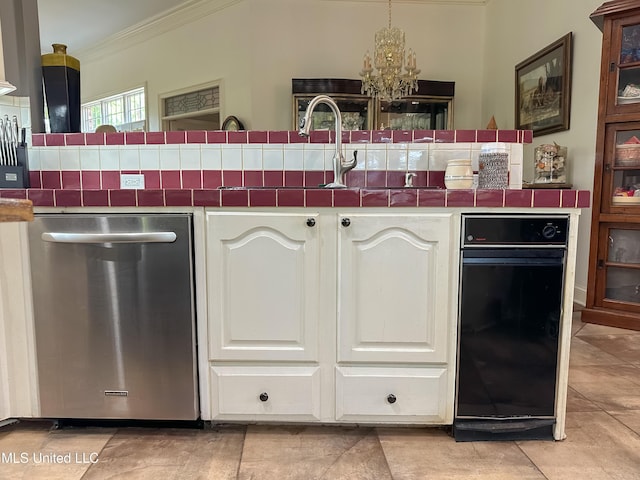 1120 Ford Rd, Terry, MS 39170 - kitchen featuring stainless steel dishwasher, ornamental molding, white cabinetry, a chandelier, and tile counters