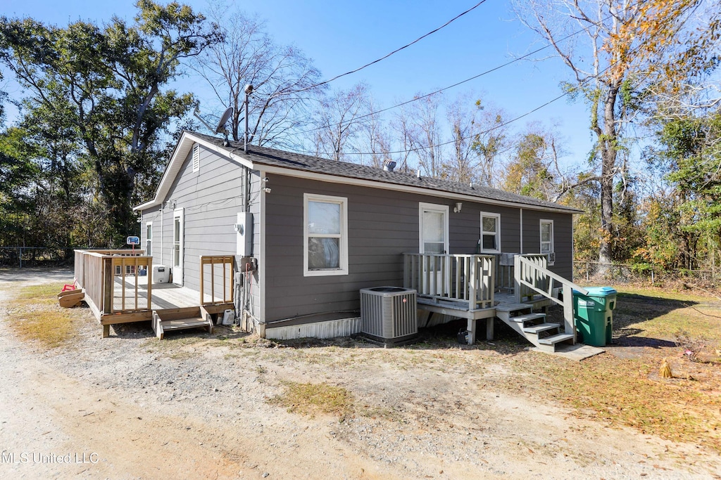 view of front of house with a wooden deck and central AC unit