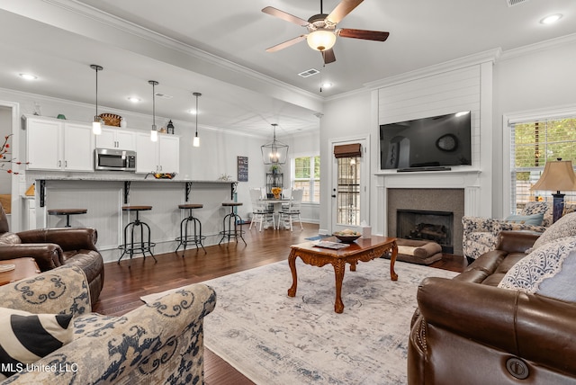 living room featuring ceiling fan, dark hardwood / wood-style flooring, and ornamental molding