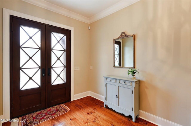 foyer with french doors, wood finished floors, baseboards, and a wealth of natural light