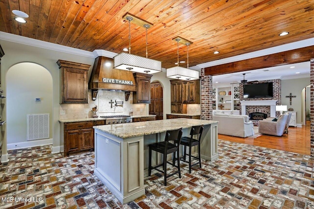 kitchen with premium range hood, visible vents, ceiling fan, arched walkways, and wood ceiling