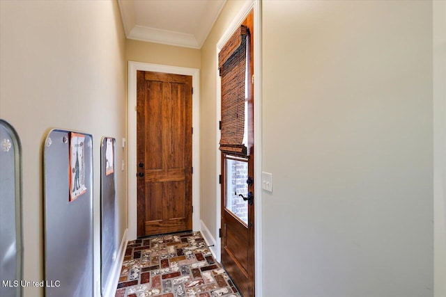 entryway with brick floor and crown molding
