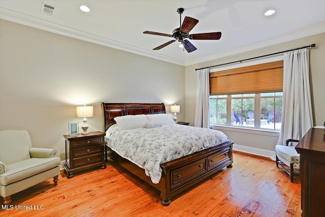 bedroom with visible vents, baseboards, ornamental molding, light wood-type flooring, and recessed lighting