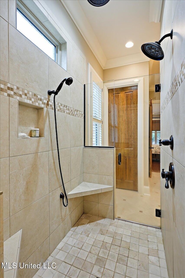 full bathroom featuring a wealth of natural light, a tile shower, and ornamental molding